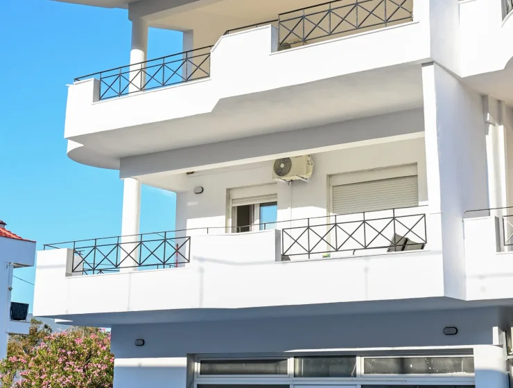 Two-story vacation maisonette with mountain and sea view, large balcony, and outdoor seating in Nea Karvali, Greece.