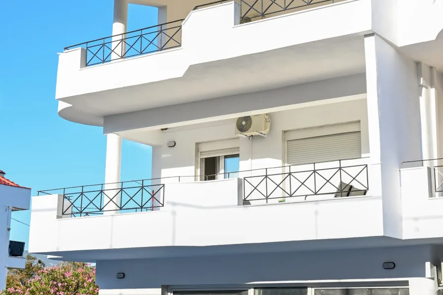Two-story vacation maisonette with mountain and sea view, large balcony, and outdoor seating in Nea Karvali, Greece.
